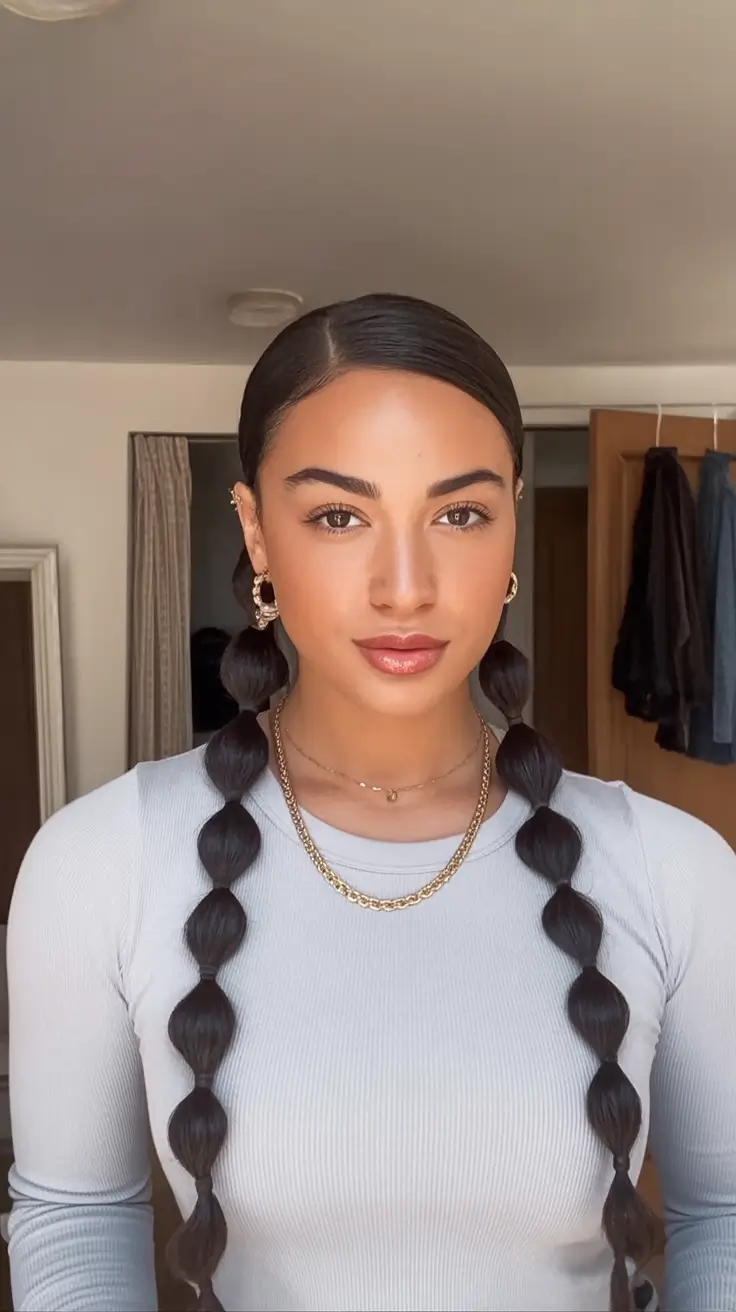 end of summer hairstyles ideas 2025 Polished Low Bubble Braids with a Middle Part