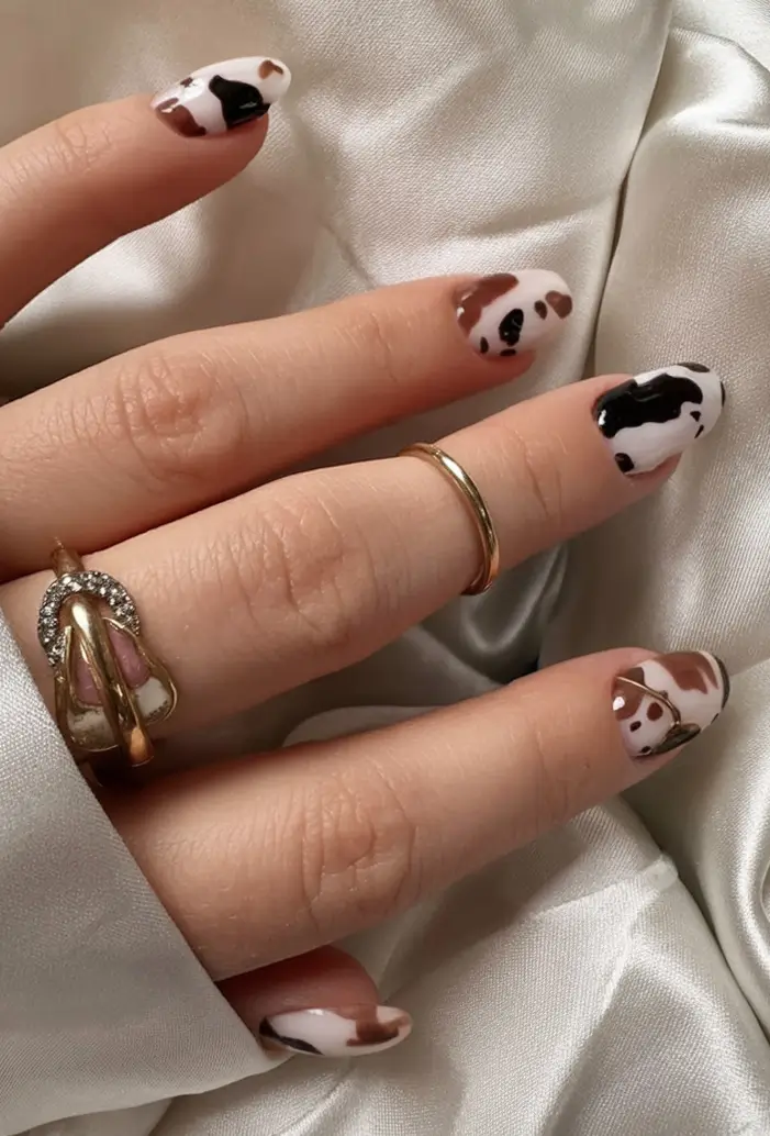 Nail Designs to Try in August 2025 Cow Print with a Hint of Sass