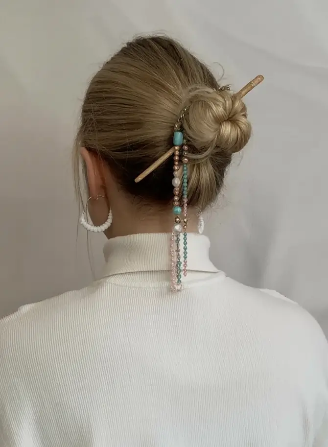Medium-Length hairstyle for Fall 2025 Chignon with Beaded Hair Stick Accent
