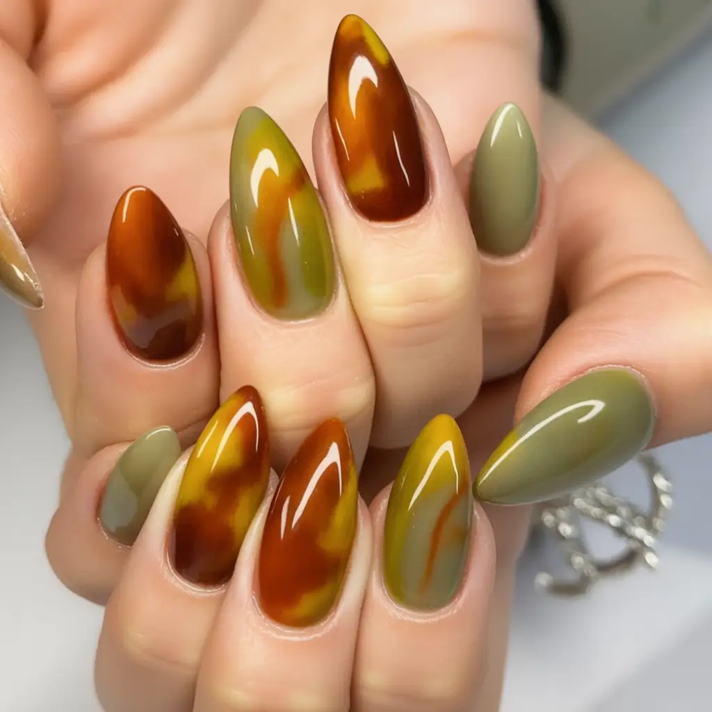trendy shades of fall nail colors 2025 olive and amber marbled drama