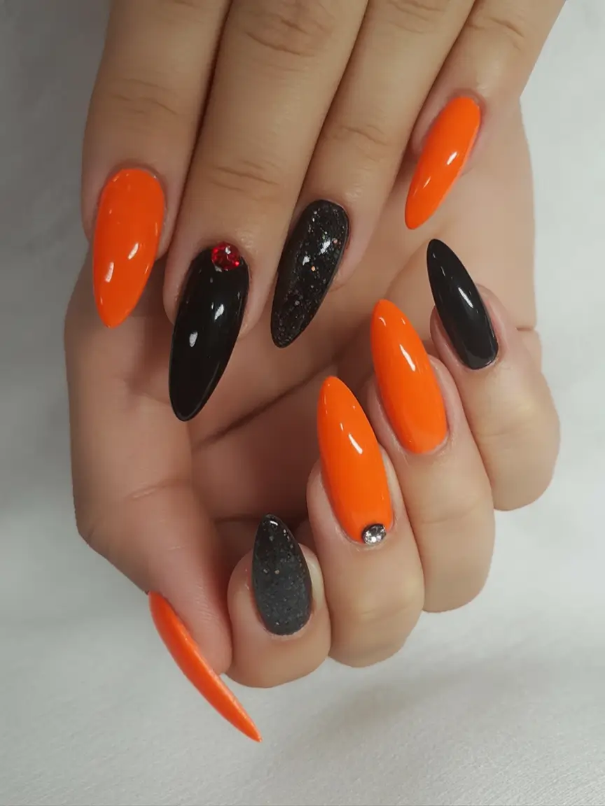 Fall 2025 Nail Color Trend Ideas Spooky-Chic Orange and Glitter Black Claws