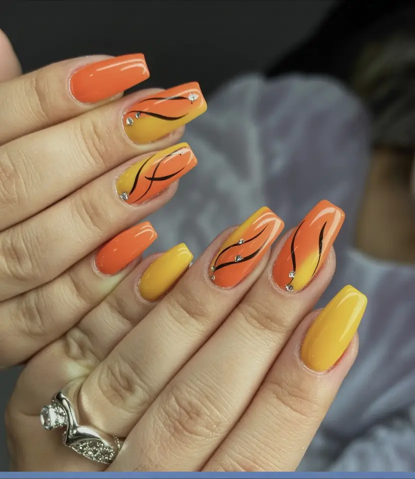 Fall Nail Colors for Medium Skin 2025 – Top Picks Sunset Orange with Black Waves