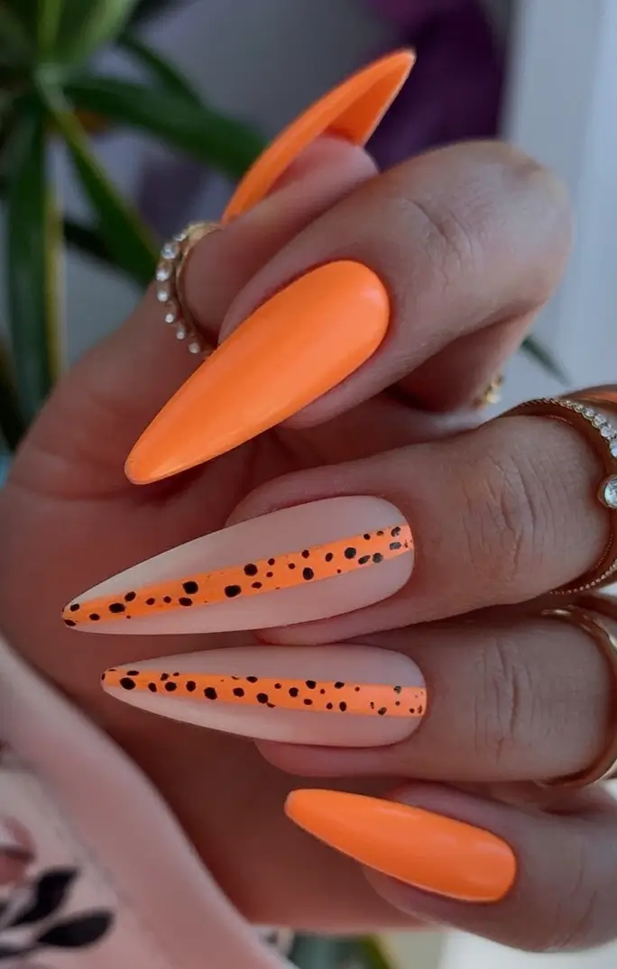 Fall Stiletto Nail Designs 2025 playful orange with speckled twist